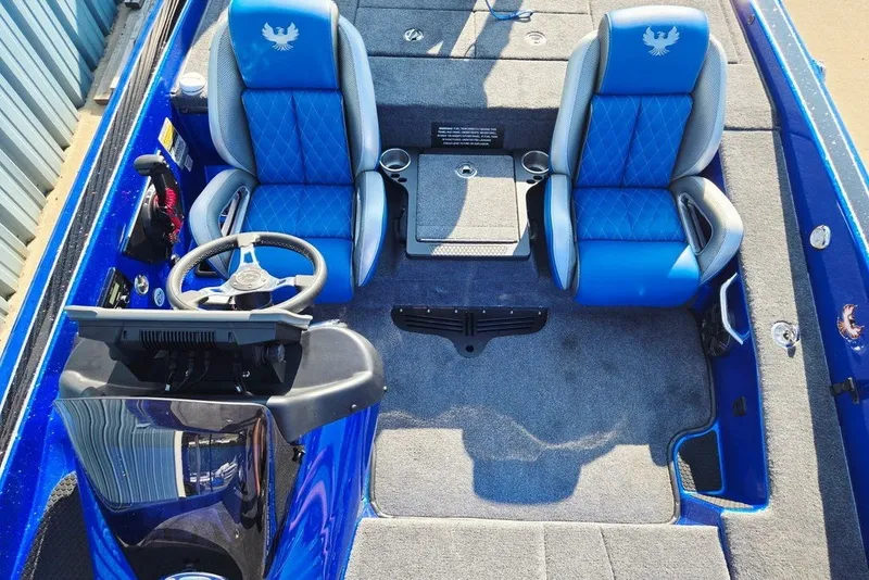 Slide: The Image of 2026 Phoenix 818 Pro boat interior with blue seats and steering console. - 32