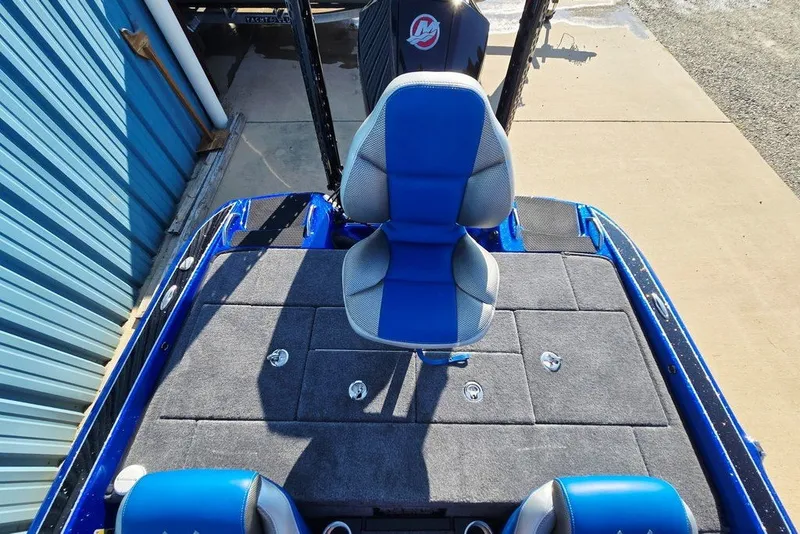 Slide: The Image of 2026 Phoenix 818 Pro boat interior with blue and gray seating and carpeted deck. - 54