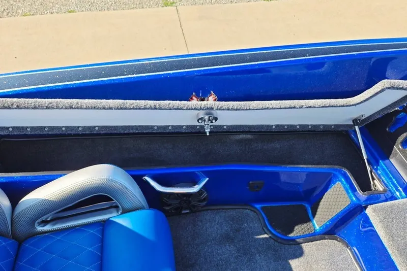 Slide: The Image of 2026 Phoenix 818 Pro boat interior with blue seating and storage compartment. - 33