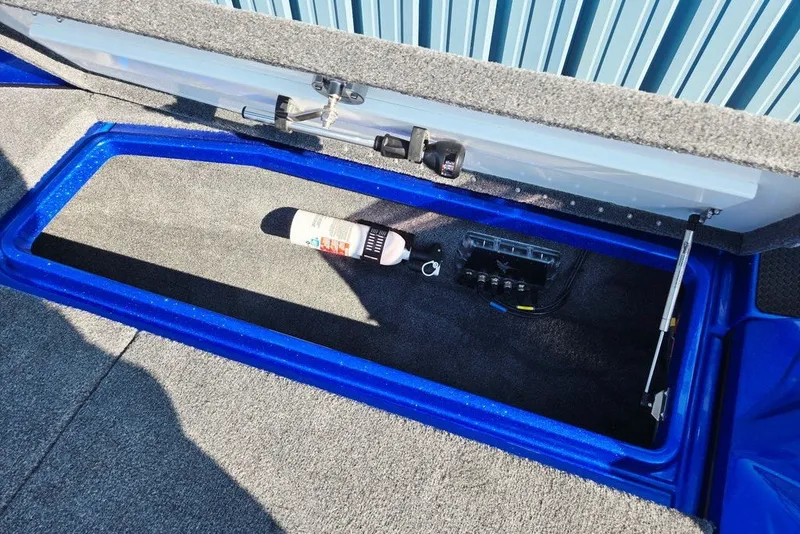 Slide: The Image of Open storage compartment in 2026 Phoenix 818 Pro boat, featuring a bottle and electrical panel. - 20