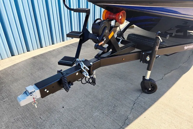 Slide: The Image of Trailer hitch of 2026 Phoenix 818 Pro boat, parked on concrete near blue wall. - 4