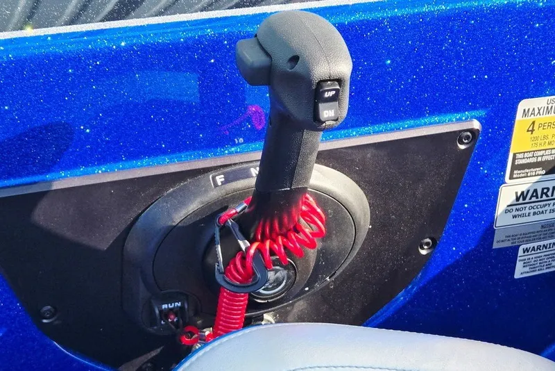 Slide: The Image of Throttle control lever on a 2026 Phoenix 818 Pro boat, featuring safety warnings and vibrant blue finish. - 53