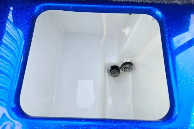 Slide: The Image of Interior view of a 2026 Phoenix 818 Pro livewell with blue trim and dual drains. - 59