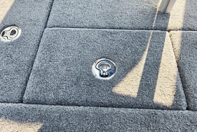 Slide: The Image of Gray carpeted deck of 2026 Phoenix 818 Pro boat with metal fixtures. - 56