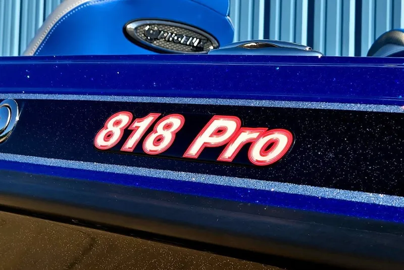 Slide: The Image of Close-up of 2026 Phoenix 818 Pro boat logo on a blue metallic surface. - 8