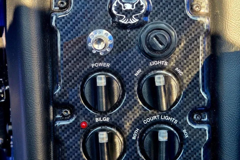 Slide: The Image of Carbon fiber control panel of 2026 Phoenix 818 Pro with switches and buttons. - 50