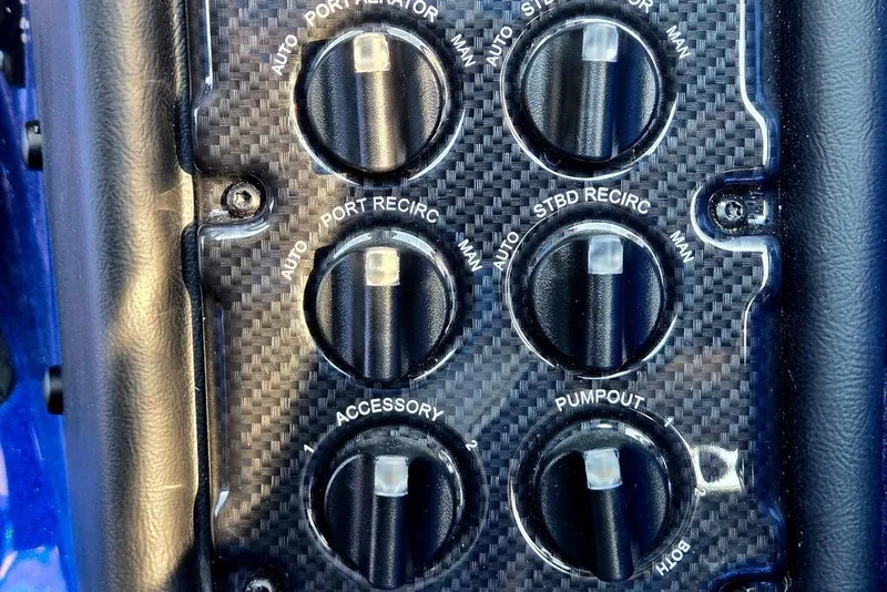 Slide: The Image of Control panel of a 2026 Phoenix 818 Pro with carbon fiber finish and labeled switches. - 51