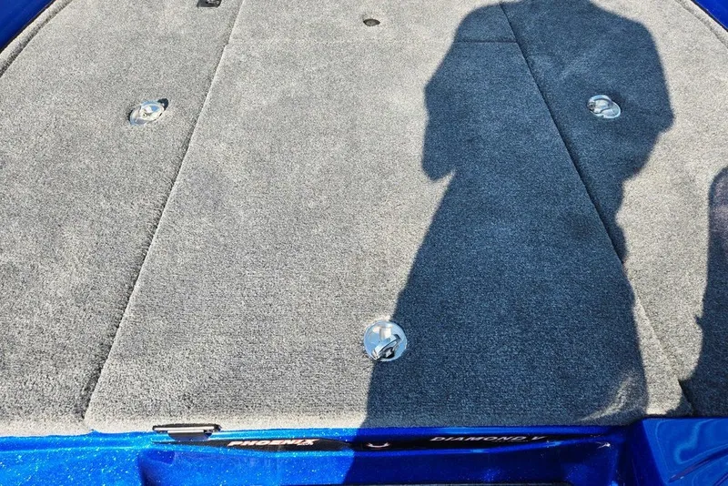 Slide: The Image of Gray carpeted deck of a 2026 Phoenix 818 Pro boat with metal fixtures. - 34