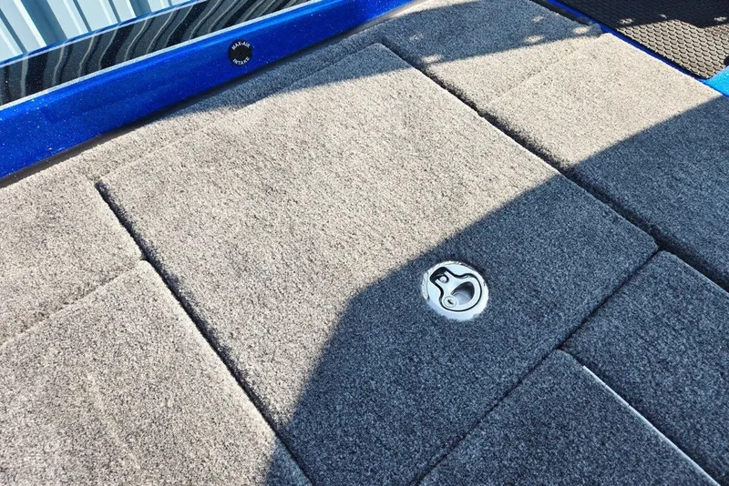 Slide: The Image of Carpeted deck of 2026 Phoenix 818 Pro boat with storage latch. - 55