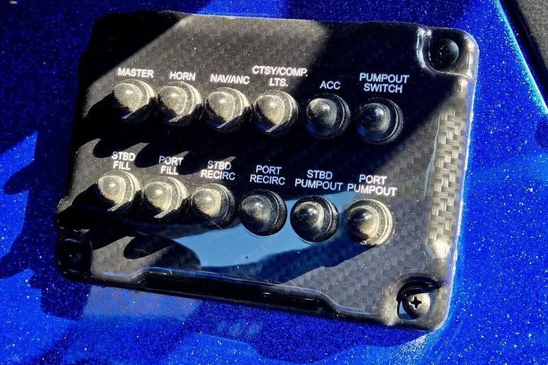 Slide: The Image of Control panel of a 2026 Phoenix 818 Pro boat with various switches. - 52