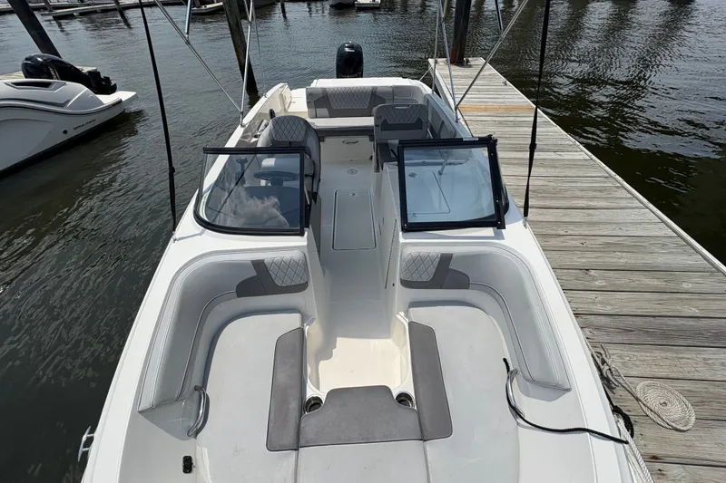Slide: The Image of 2023 Bayliner VR6 Bowrider OB docked, showcasing spacious seating and sleek design. - 4