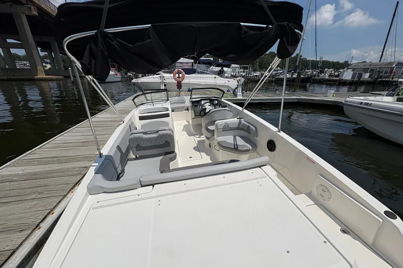 Slide: The Image of 2023 Bayliner VR6 Bowrider OB docked, featuring spacious seating and canopy. - 5