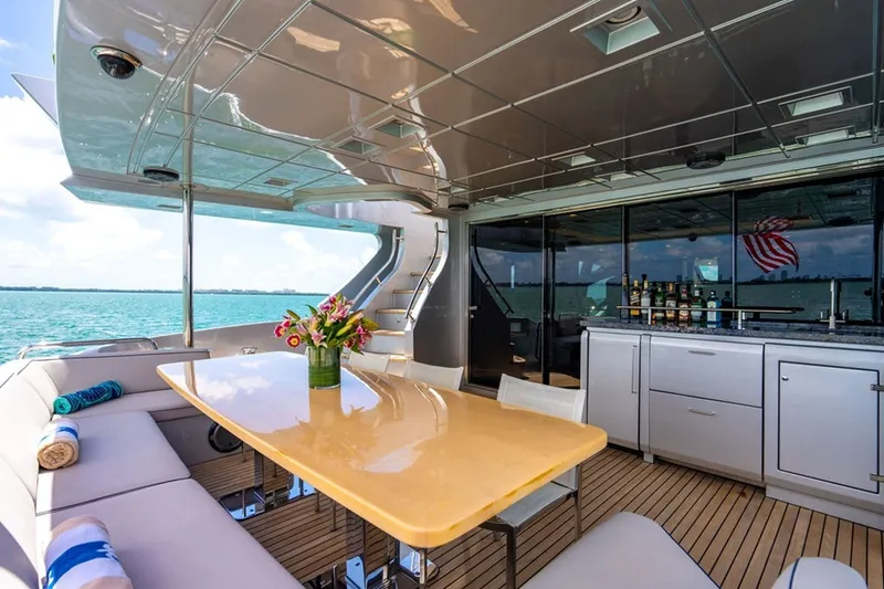 Slide: The Image of Luxurious 2008 Azimut 95 yacht deck with dining area, ocean view, and elegant decor. - 24