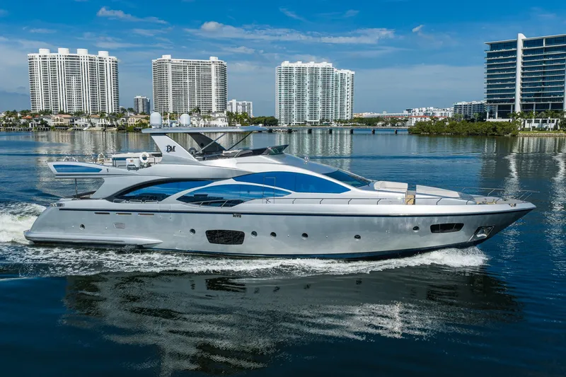 The Image of Luxurious 2008 Azimut 95 yacht cruising near modern waterfront buildings. - 1