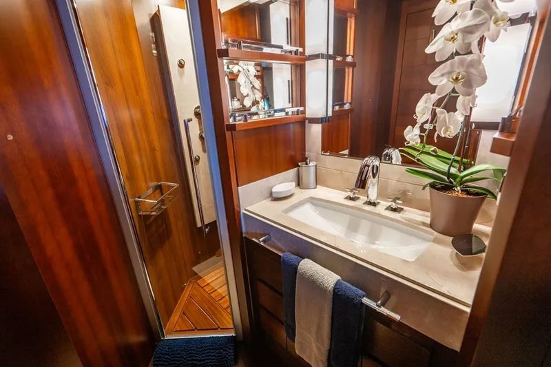 Slide: The Image of Luxurious bathroom on 2008 Azimut 95 yacht with elegant wood finishes and orchid decor. - 20