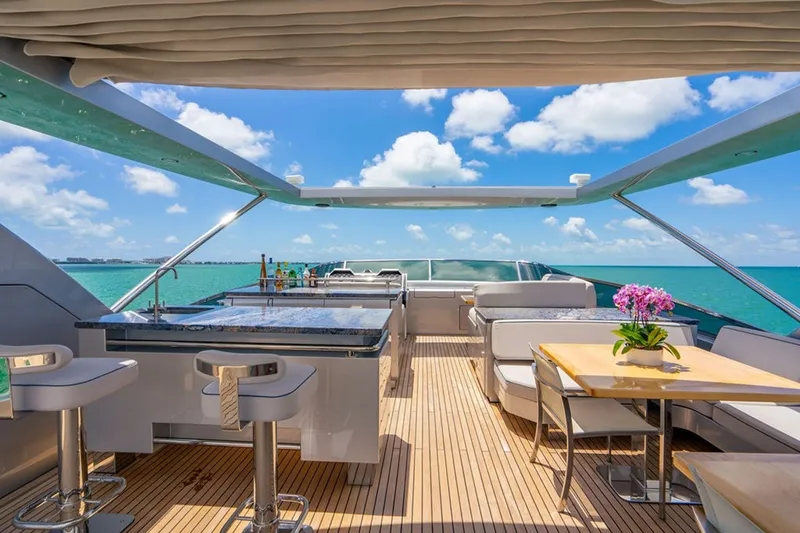 Slide: The Image of Luxurious 2008 Azimut 95 yacht deck with bar, seating, and ocean view. - 29