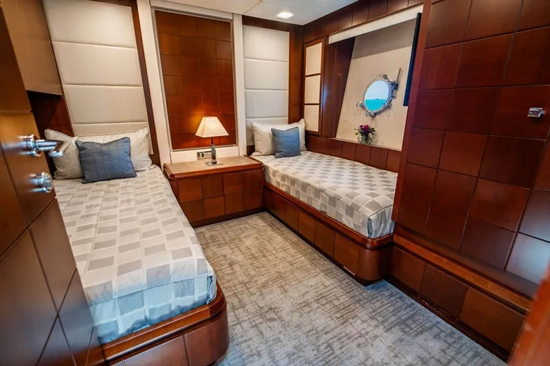 Slide: The Image of Luxurious twin cabin interior on 2008 Azimut 95 yacht, featuring elegant wood paneling and modern decor. - 17