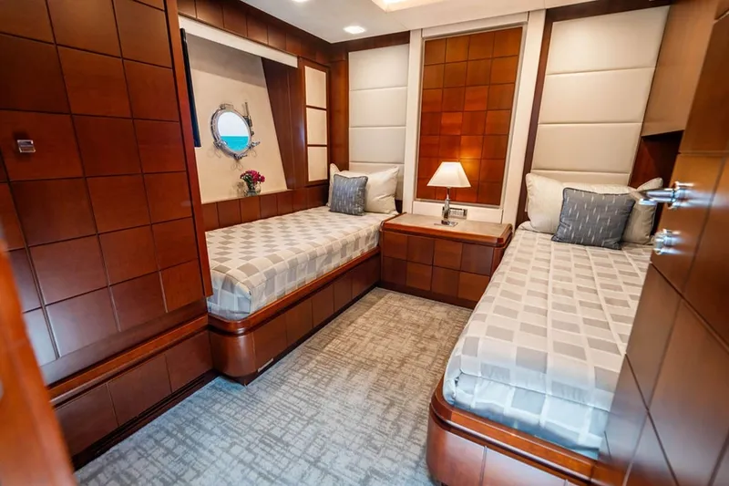 Slide: The Image of Luxurious twin cabin on 2008 Azimut 95 yacht with elegant wood paneling and modern decor. - 19
