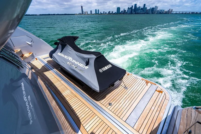 Slide: The Image of Luxury Azimut 95 yacht deck with Yamaha WaveRunner, ocean view, city skyline in background. - 33