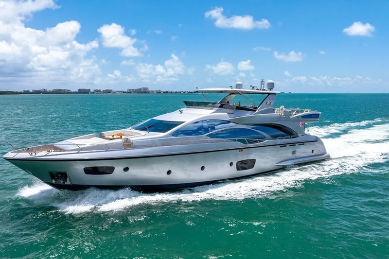 Slide: The Image of Luxury 2008 Azimut 95 yacht cruising on turquoise ocean under clear blue sky. - 37