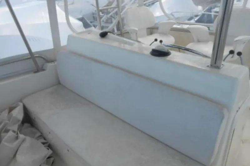 Slide: The Image of 1997 Riviera 34 Convertible boat interior with cushioned seating and helm chairs. - 31