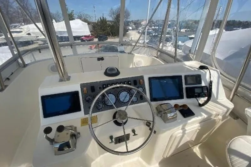 Slide: The Image of Cockpit of 1997 Riviera 34 Convertible boat with steering wheel and navigation equipment. - 18