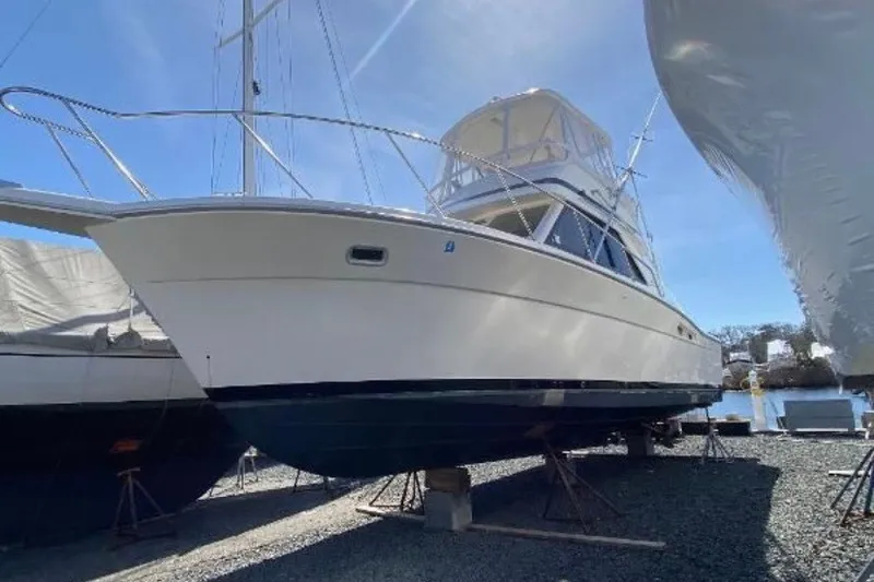 Slide: The Image of 1997 Riviera 34 Convertible yacht on dry dock under clear blue sky. - 8