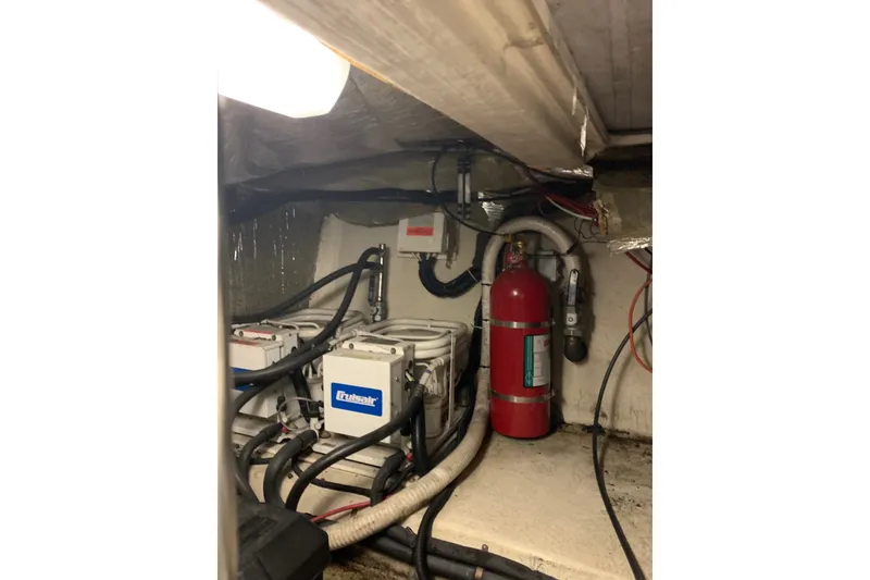 Slide: The Image of Engine room of 1997 Riviera 34 Convertible with fire extinguisher and wiring. - 44