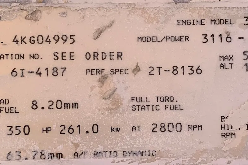 Slide: The Image of Close-up of a weathered engine specification plate for a 1997 Riviera 34 Convertible. - 52
