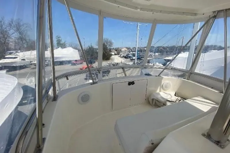 Slide: The Image of Interior view of 1997 Riviera 34 Convertible yacht with panoramic windows and seating area. - 16