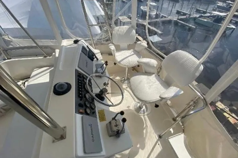 Slide: The Image of Interior of 1997 Riviera 34 Convertible yacht with helm and seating. - 17
