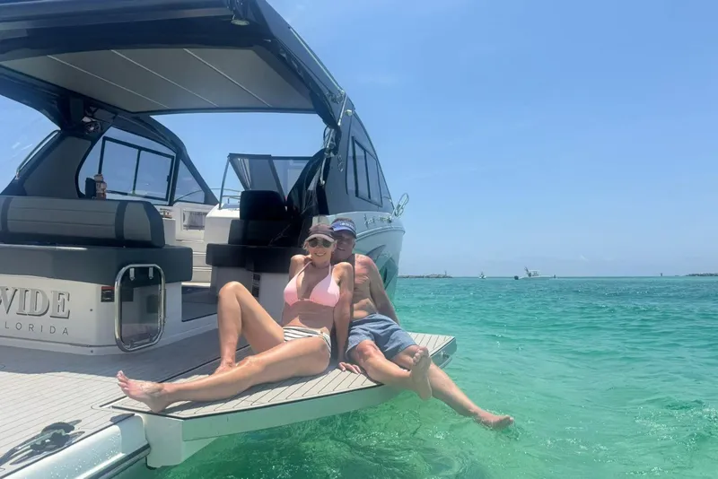 Slide: The Image of Couple relaxing on Hanover 387 yacht, 2025 model, in clear turquoise waters. - 4