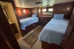 Slide: The Image of 1978 Hatteras 43 Double Cabin interior with twin beds and wooden furnishings. - 21