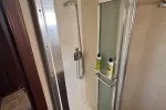 Slide: The Image of 1978 Hatteras 43 Double Cabin shower area with toiletries and sliding glass door. - 18