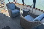 Slide: The Image of 1978 Hatteras 43 Double Cabin interior with wicker chairs and table. - 29