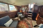 Slide: The Image of Interior of 1978 Hatteras 43 Double Cabin with cozy seating and nautical decor. - 22