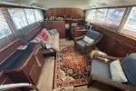 Slide: The Image of 1978 Hatteras 43 Double Cabin interior with cozy seating and elegant decor. - 24