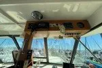 Slide: The Image of Interior helm of 1978 Hatteras 43 Double Cabin yacht with marina view. - 25