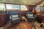 Slide: The Image of Interior of 1978 Hatteras 43 Double Cabin with cozy seating and nautical decor. - 17