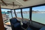 Slide: The Image of 1978 Hatteras 43 Double Cabin interior with marina view through large windows. - 12