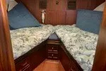 Slide: The Image of 1978 Hatteras 43 Double Cabin interior with twin beds and wooden cabinetry. - 9