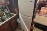 Slide: The Image of 1978 Hatteras 43 Double Cabin kitchen with fridge and wooden cabinetry. - 16