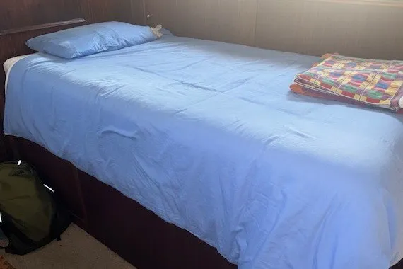 Slide: The Image of Single bed with blue sheets in a 1978 Hatteras 43 Double Cabin yacht. - 7
