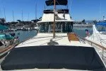 Slide: The Image of 1978 Hatteras 43 Double Cabin yacht docked in a marina under clear blue skies. - 5