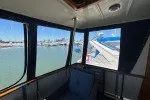 Slide: The Image of Interior view of a 1978 Hatteras 43 Double Cabin yacht with marina backdrop. - 11