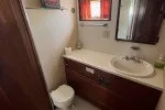 Slide: The Image of 1978 Hatteras 43 Double Cabin bathroom with sink, mirror, and toilet. - 20