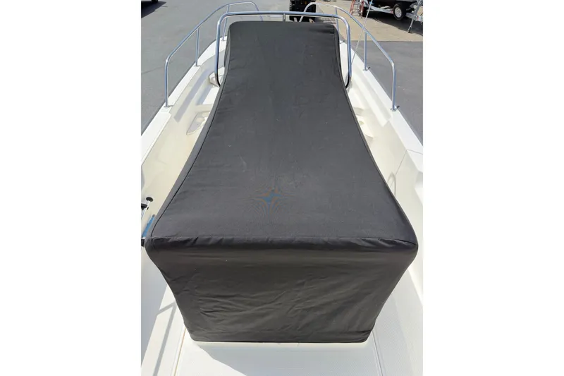 Slide: The Image of 2022 Boston Whaler 170 Montauk boat with black protective cover on deck. - 16