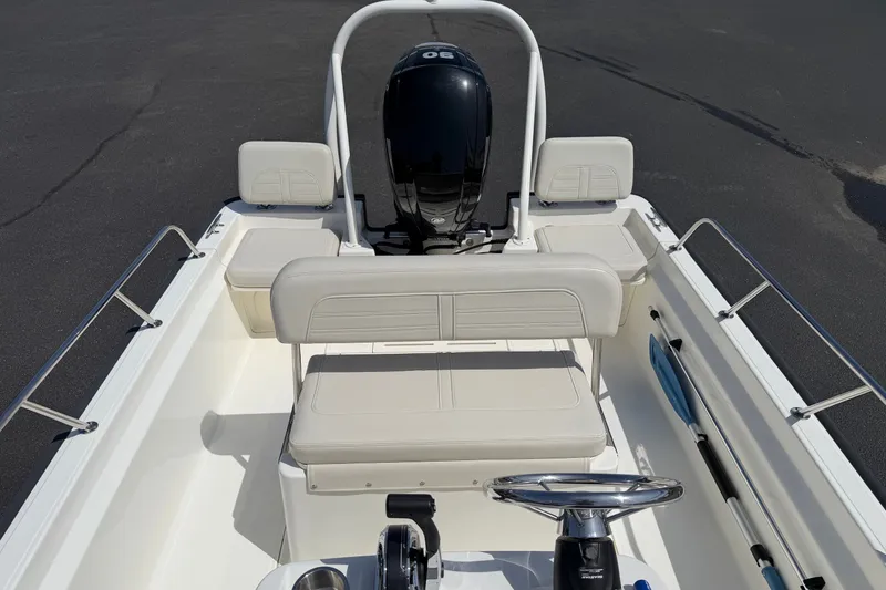 Slide: The Image of 2022 Boston Whaler 170 Montauk boat interior with seating and steering wheel. - 9