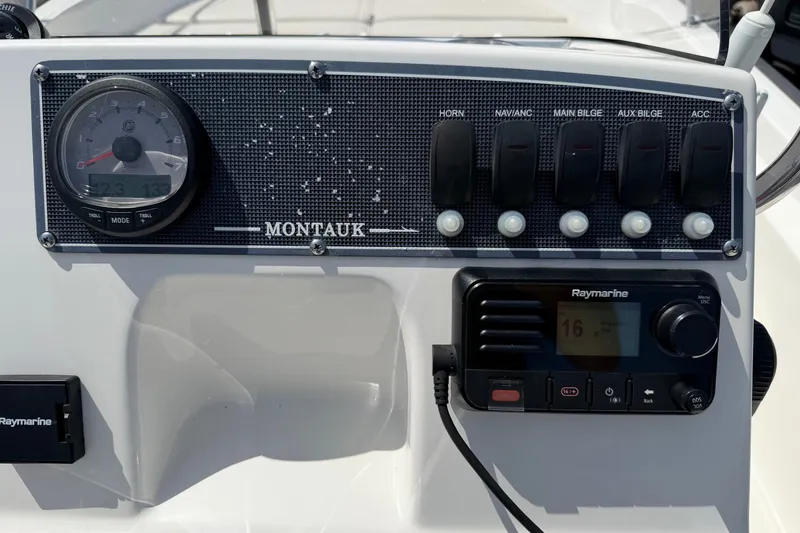 Slide: The Image of Control panel of a 2022 Boston Whaler 170 Montauk boat with gauges and switches. - 14