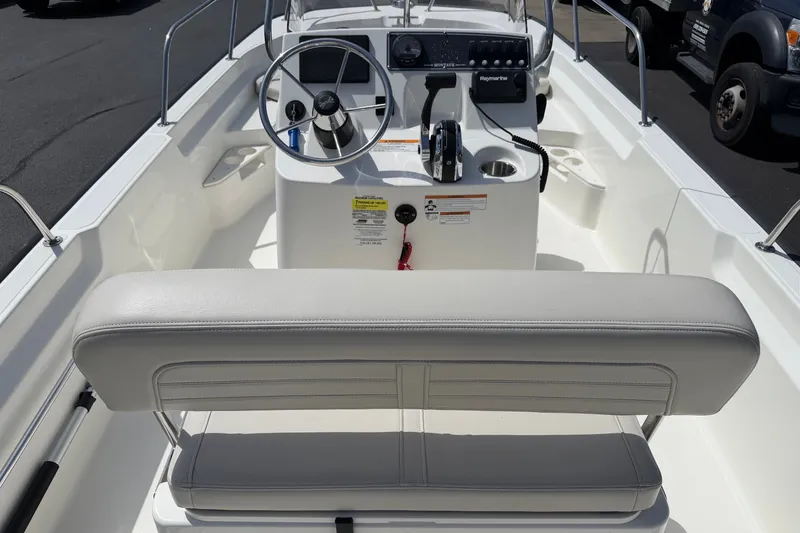 Slide: The Image of 2022 Boston Whaler 170 Montauk boat interior with steering console and seating. - 11